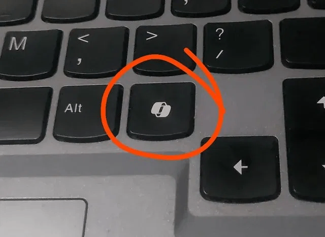 Close-up photo of a laptop keyboard with the dedicated Copilot key circled